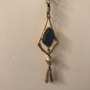 Long statement necklace. Gold chain, blue pendant